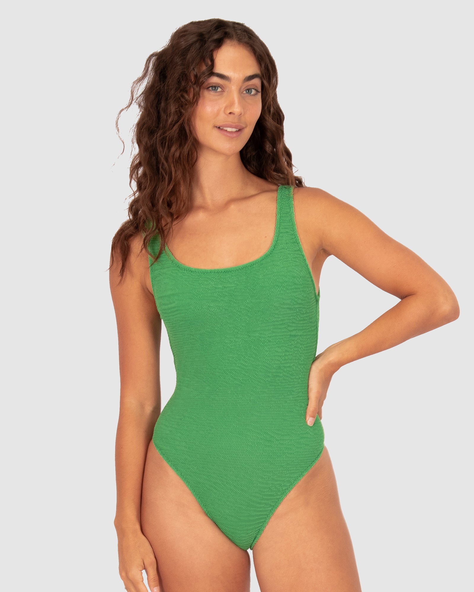 Ibiza Low Back One Piece in moss crinkle fabric offering low back style, elongated legline, rio cut coverage, shelf support, and removable cups from Australian swimwear brand Baku.