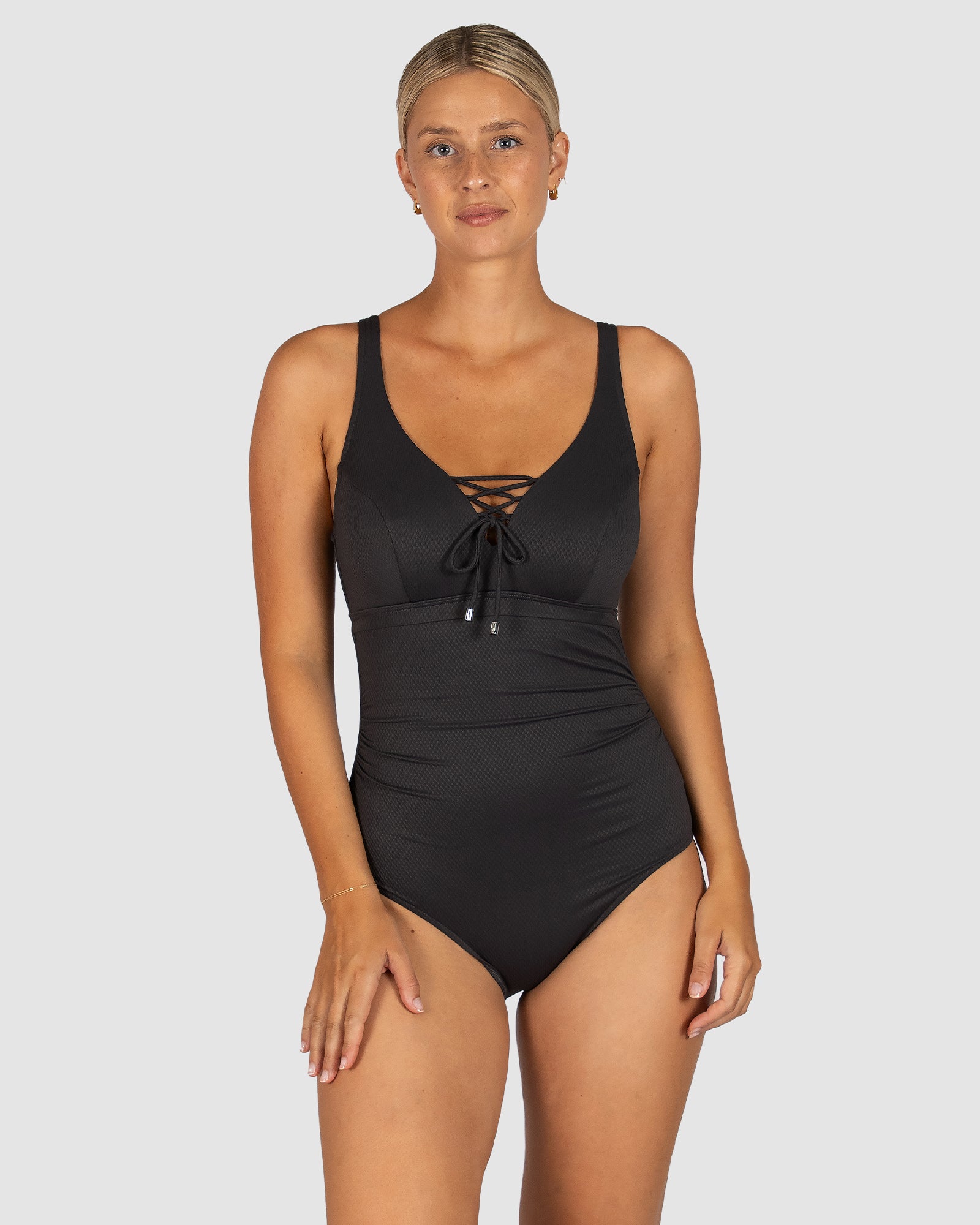 Baku is a premium Australian swimwear brand. The Rococco E-F-G One Piece Swimsuit in Cacao, a warm and earthy dark taupe, is crafted from luxurious Spanish textural fabric. Designed for fuller busts, it features a flattering dropped neckline with lace-up detail, hidden underwire with power mesh, boning and Lycra cup support. With tummy control, convertible straps, and a secure clip back, this one piece offers both structure and elegance.

