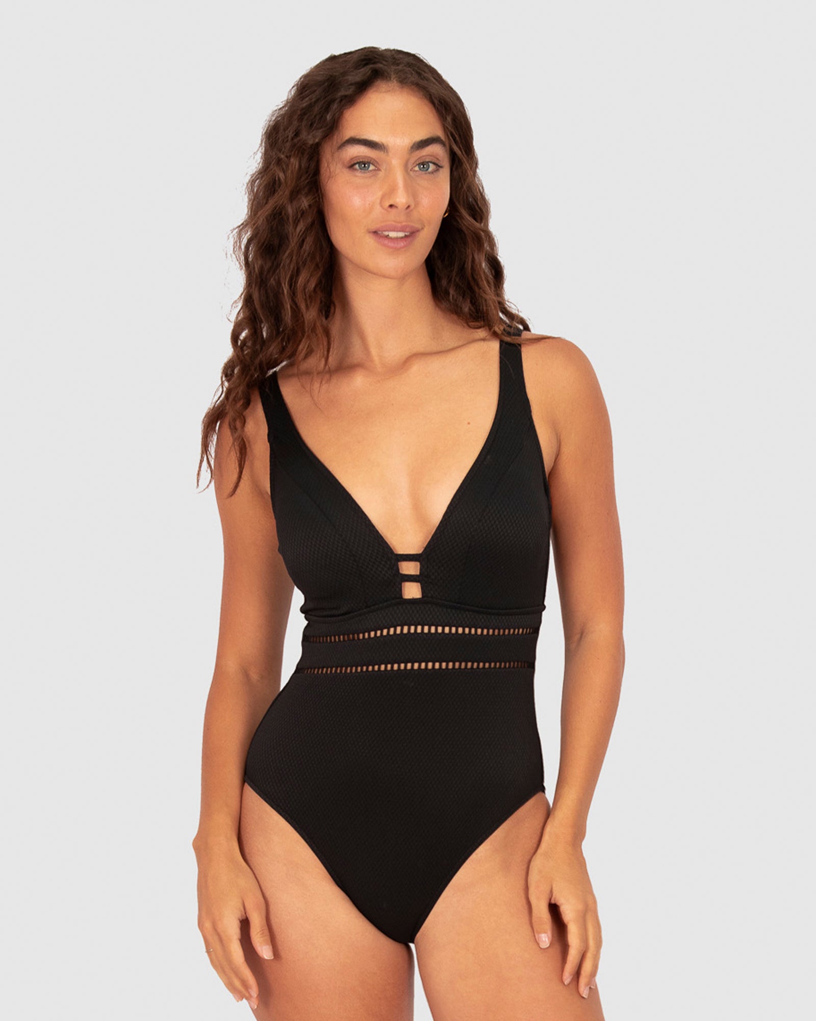 Baku’s Rococco C-DD Plunge One Piece in Nero offers timeless sophistication in classic black. Made from exclusive Spanish textural fabric, it features a deep plunge neckline, delicate ladder lace detailing, dipped back, and supportive underwire with removable cups. Convertible straps ensure a personalised and flattering fit.