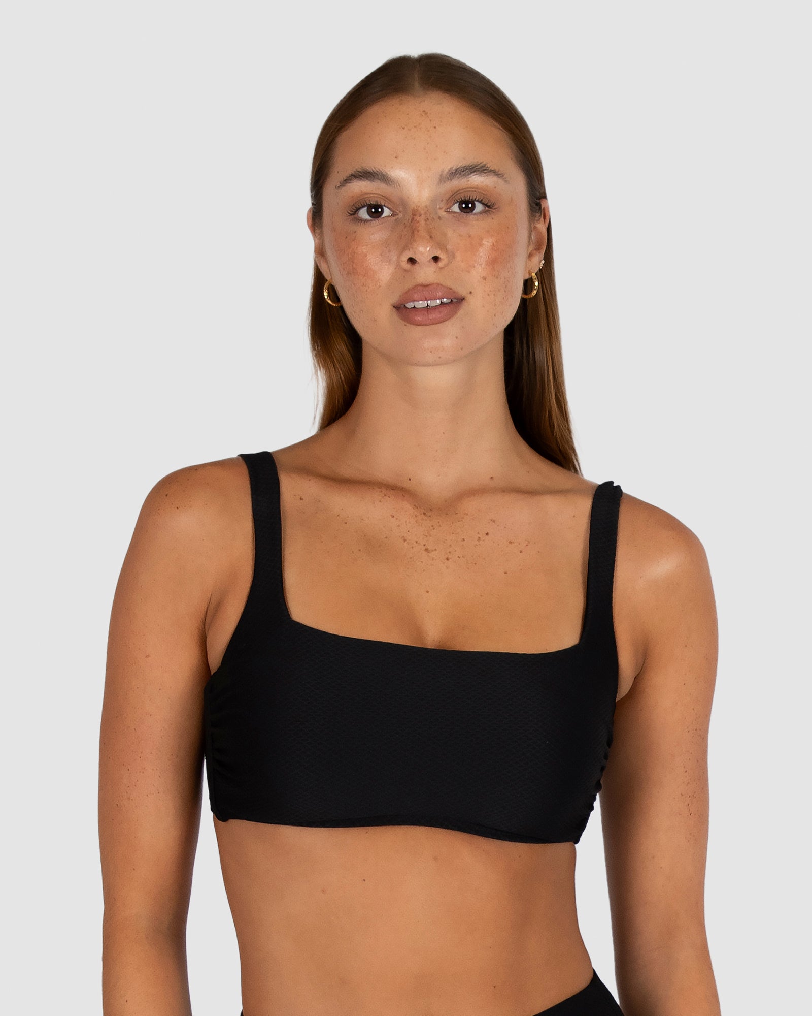 Baku is a premium Australian swimwear brand. The Rococco Multifit Bralette Bikini Bra in Nero, a timeless classic black, is made from luxurious Spanish textured fabric. Designed to flatter A to D cup sizes, it features a square neckline, removable cups, supportive boning, adjustable straps, and a secure clip back—delivering elegance, comfort, and clean lines.