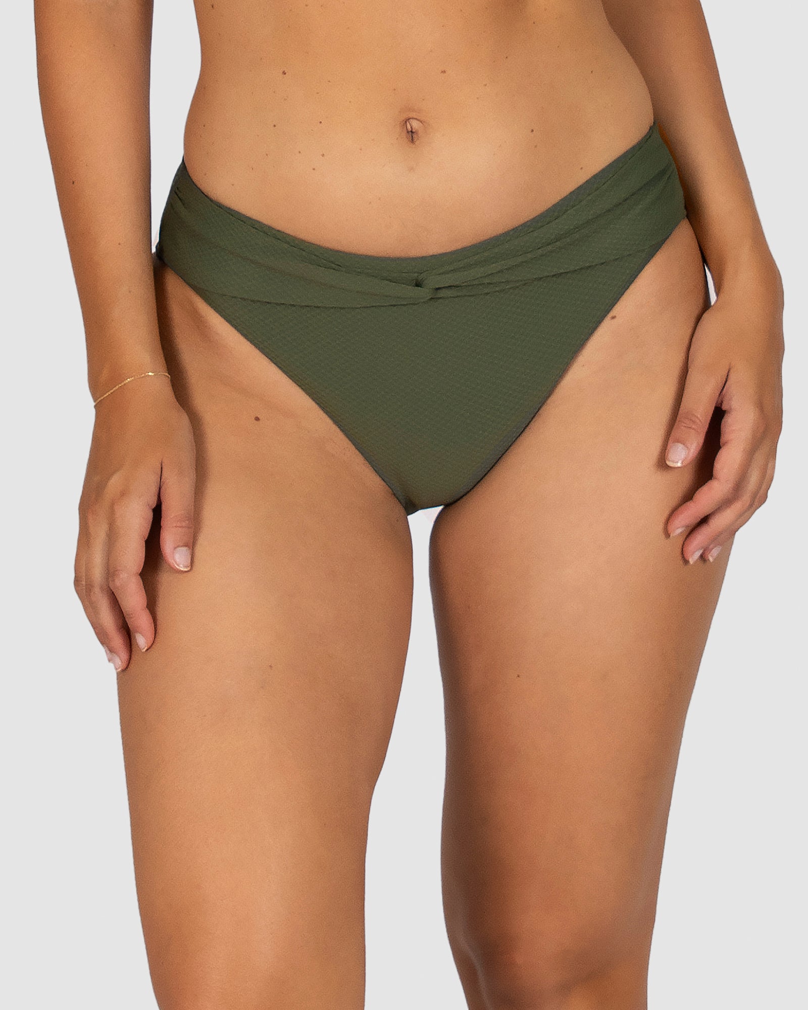 From Australian swimwear label Baku, the Rococco Cabana Pant in Amazon blends earthy tone with refined structure. This bikini bottom features a twisted belt accent, mid-rise fit, and power mesh tummy control. Crafted from soft yet structured Spanish fabric for a clean, confident look.