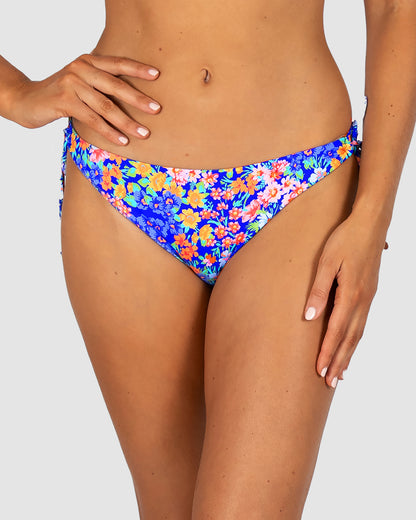 Biarritz loopside bikini bottom with keyhole side ties and cheeky Rio coverage, in a vibrant floral print.