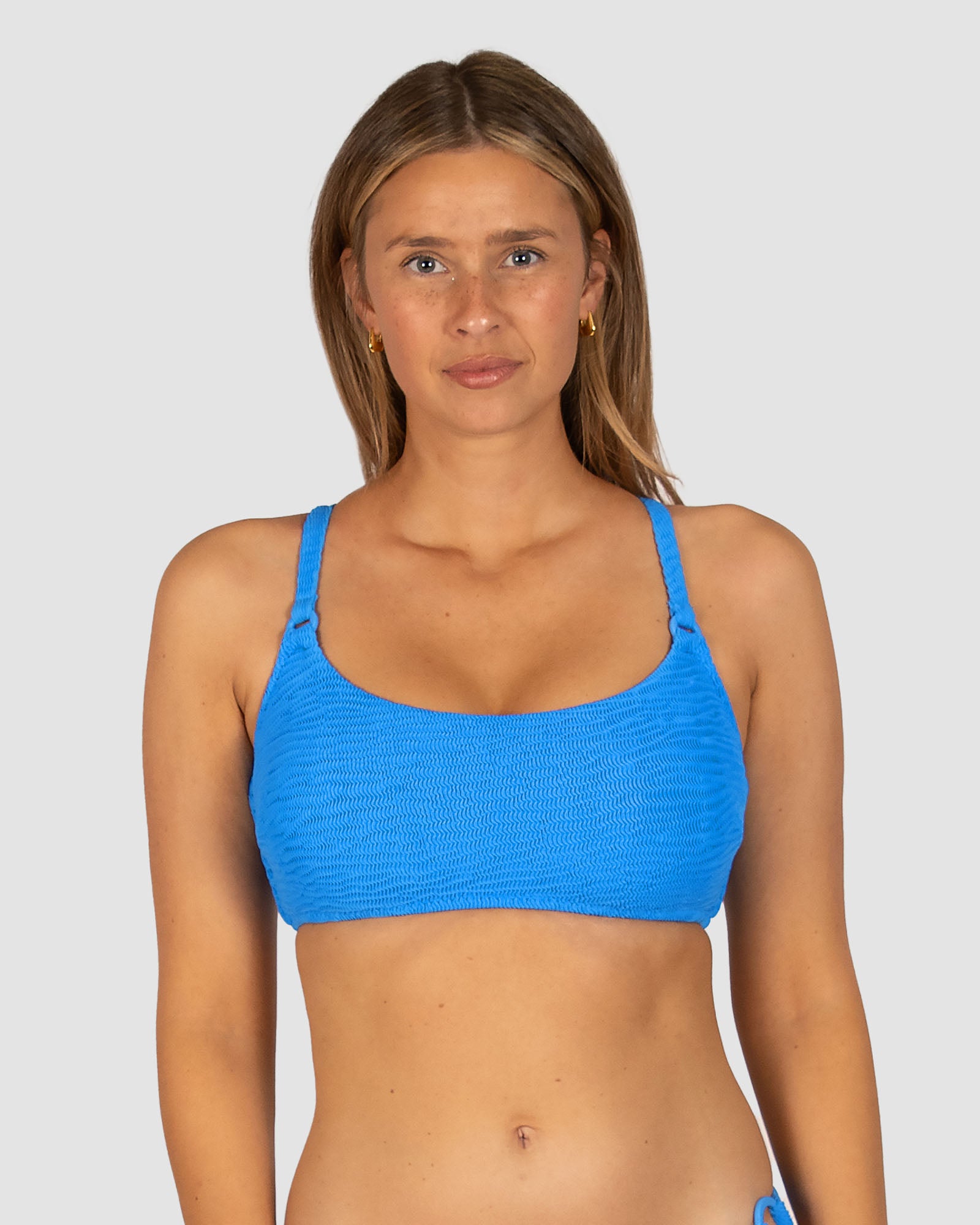 Ibiza E–F Cup Bralette Bikini Top in blue crinkle fabric featuring boning and lycra support, removable cups, adjustable convertible straps, and clip-back fastening by Australian swimwear brand Baku.