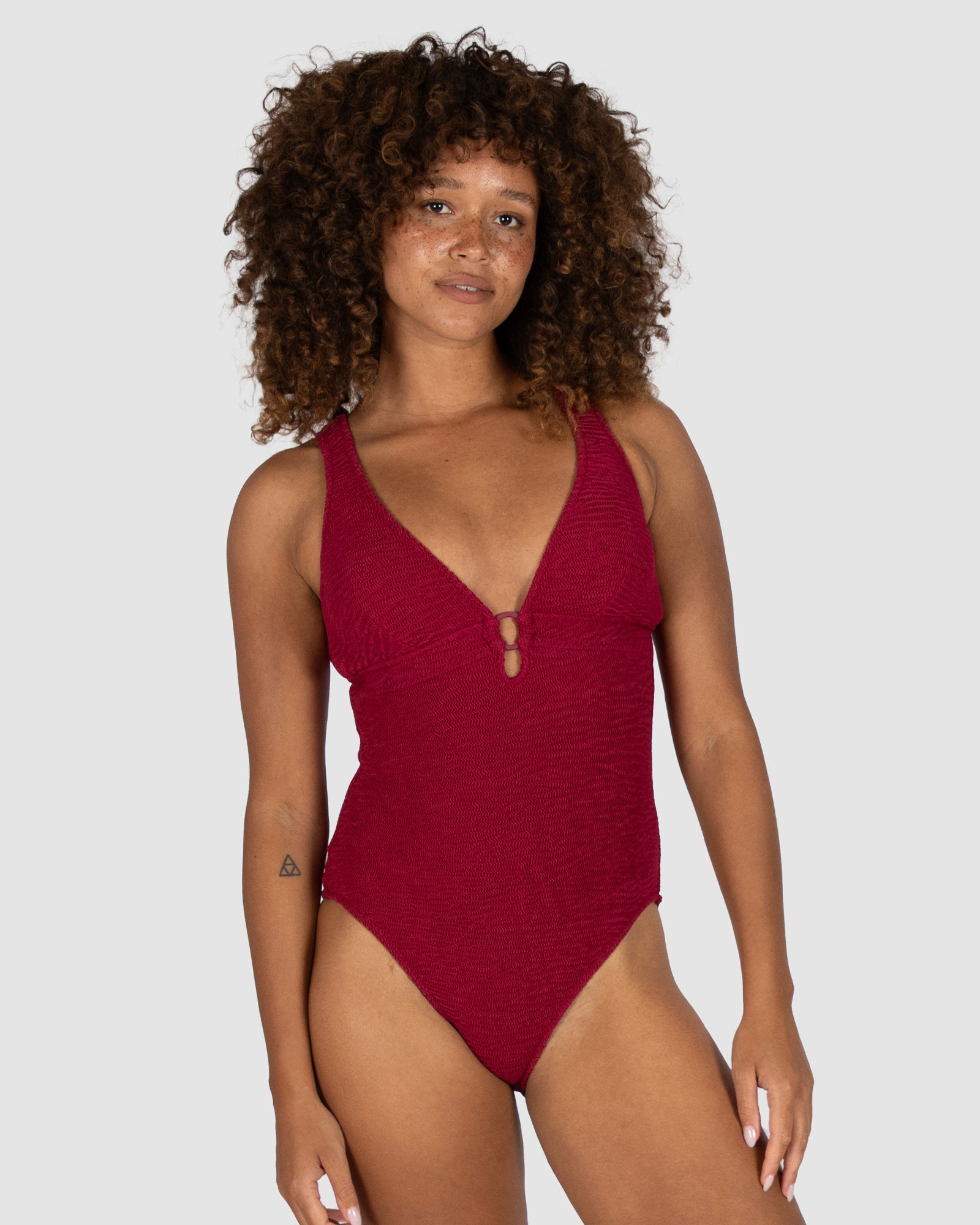 Ibiza Longline One Piece in scarlet crinkle fabric with flattering low neckline, ring accent, removable cups, and internal boning for shape from Australian swimwear brand Baku.