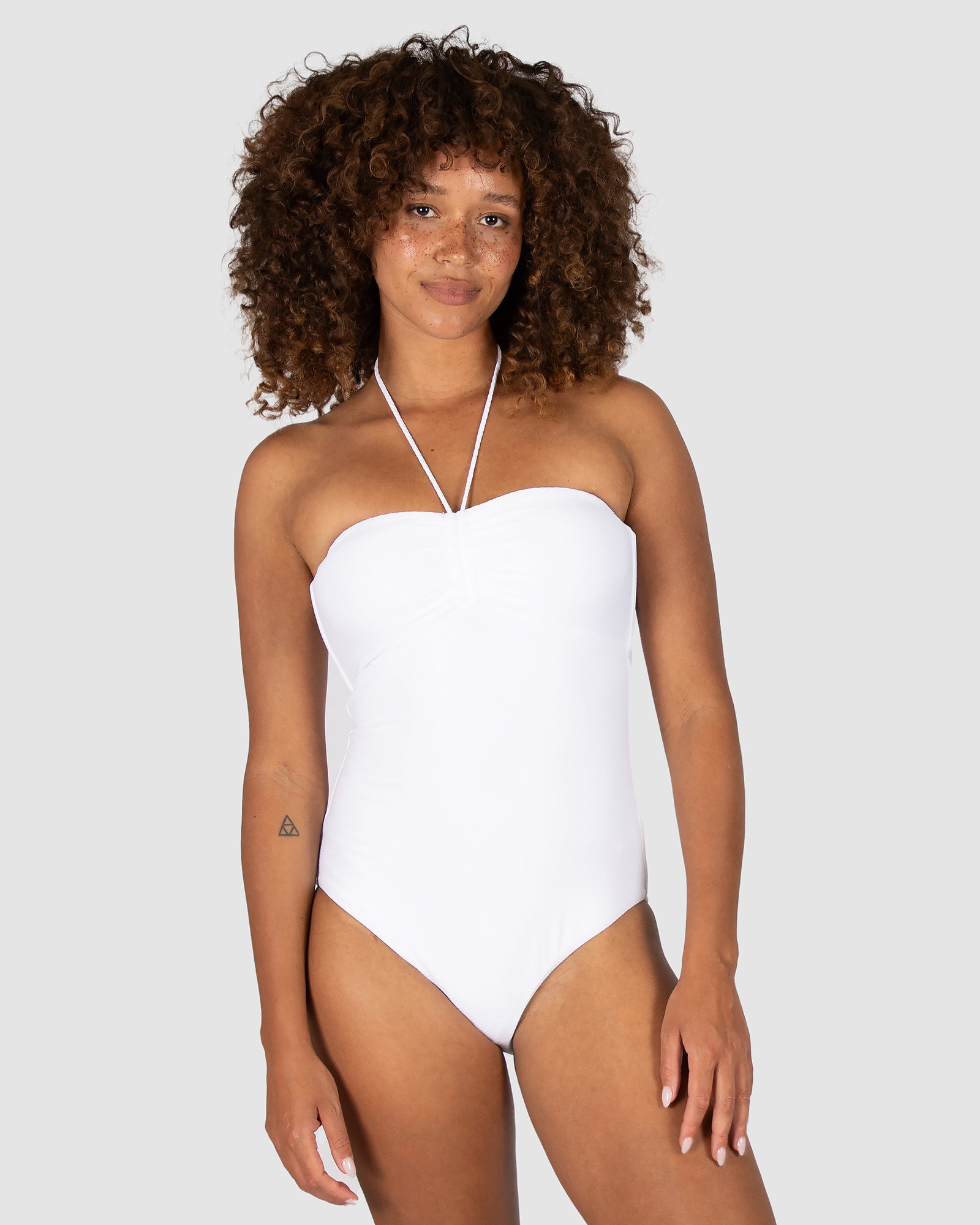 Baku is a premium Australian swimwear brand. The Rococco Multi Fit Bandeau One Piece Swimsuit features soft removable cups with an optional neck tie, supportive side boning, and gripper tape. Made from exclusive Spanish textured fabric, it offers a secure, strapless fit with a sculpted silhouette designed for multi-cup versatility.