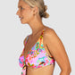 Woman wearing a colorful floral bikini against a plain background