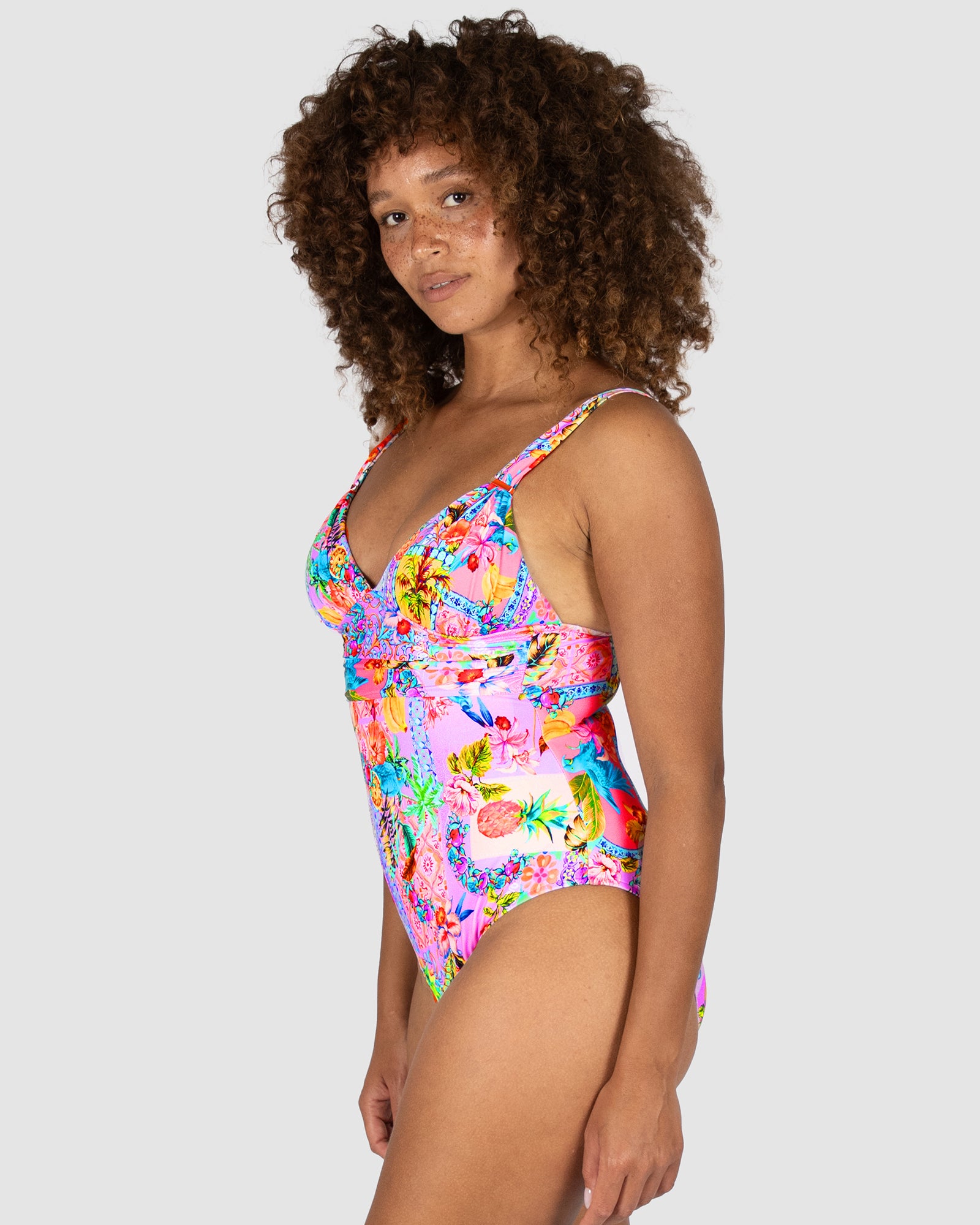  Side view of Baku Sardinia Grecian One Piece Swimsuit showing ruched detailing and rose gold bar trim.