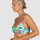 Woman wearing a colorful floral bikini against a white background
