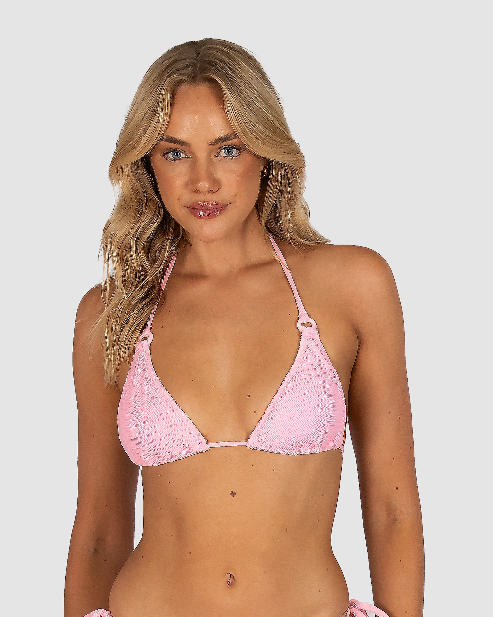 Ibiza Slide Triangle Bikini Top in pink sorbet crinkle fabric with tactile texture, removable cups, and adjustable ties at neck and back, tailored to A–C cup fit by Australian swimwear brand Baku.