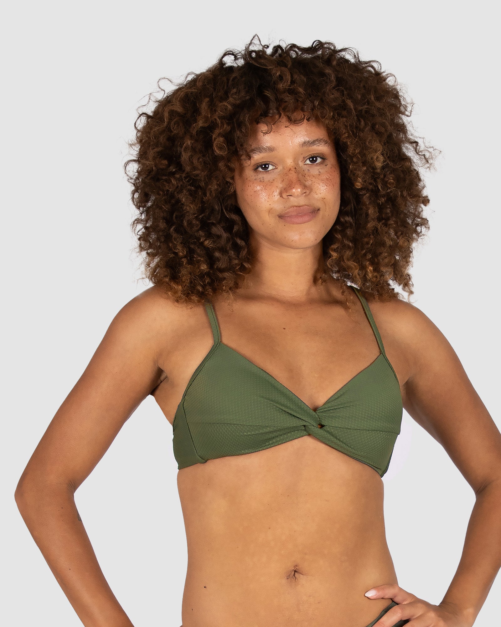Crafted by Australian swimwear brand Baku, the Rococco Multifit Bralette Bikini Bra in Amazon brings earthy depth in a rich olive green tone. With a twist front detail, removable soft cups, adjustable and convertible straps, and a clip back closure, this top offers both structure and natural elegance in Spanish-developed fabric.