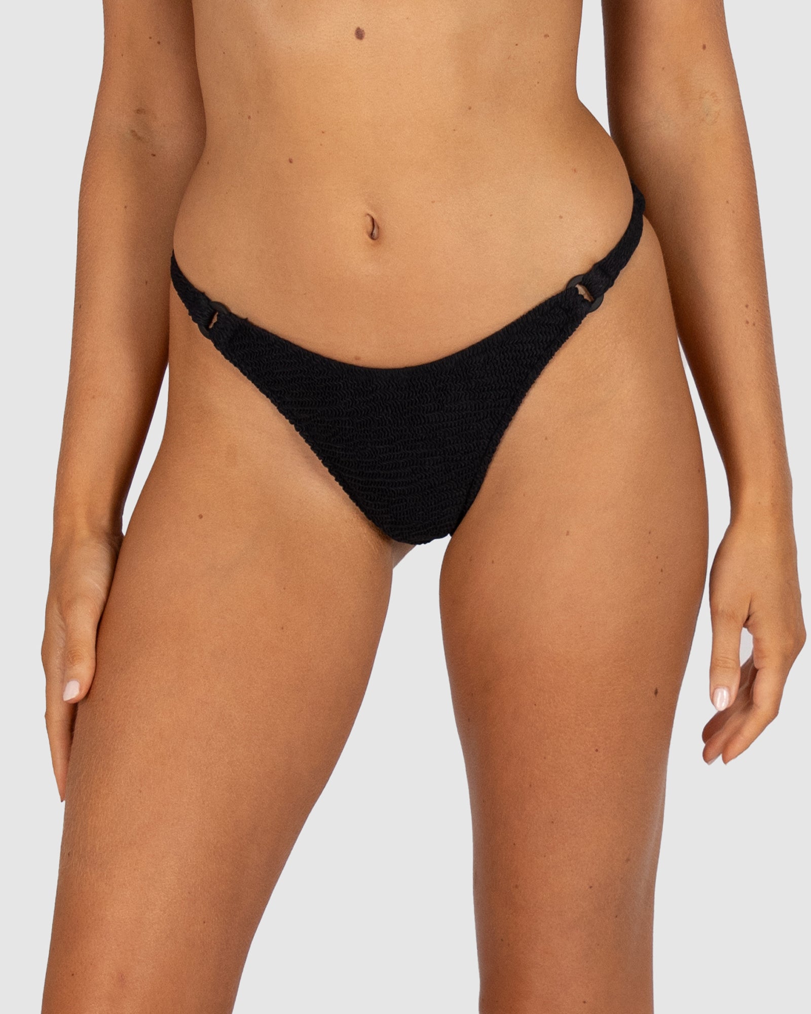 Ibiza Brazilian Bikini Pant in black crinkle fabric designed with ring front feature and Brazilian back coverage by Australian swimwear brand Baku.