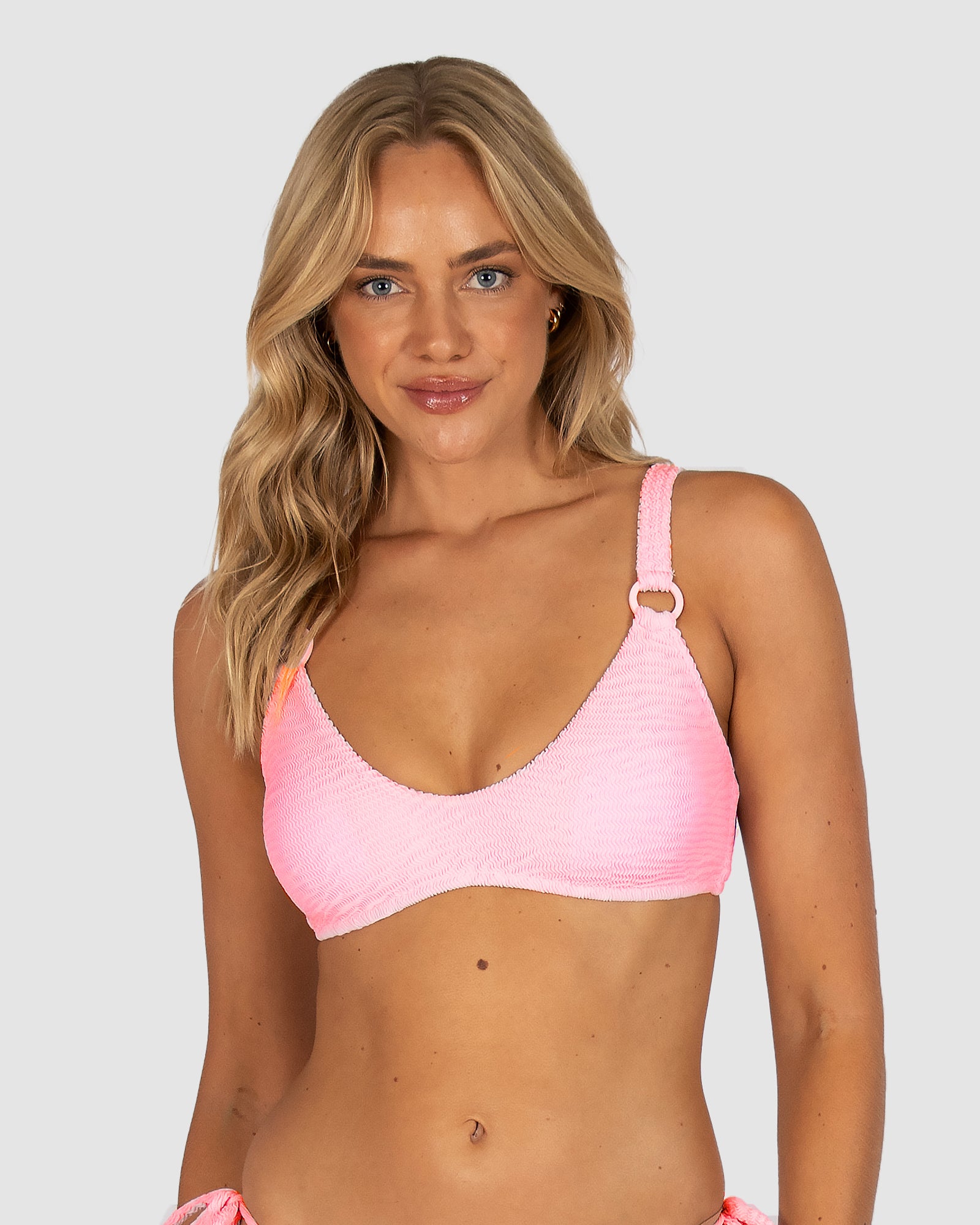 Ibiza Scoop Bralette Bikini Top in pink sorbet crinkle fabric featuring scoop front, ring accent, soft removable cups, and secure clip-back closure by Australian swimwear brand Baku.