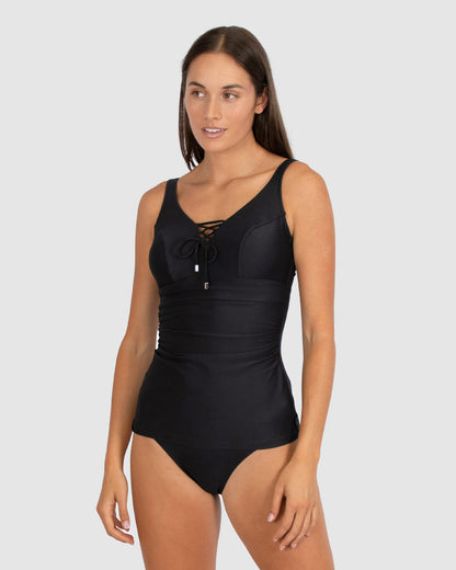 Baku is a premium Australian swimwear brand. The Rococco F/G Underwire Tankini Swim Top in Nero, a timeless black shade, offers sophisticated support with a lace-up front neckline and Spanish textural fabric. Hidden underwire, boning, and power mesh cup lining provide shaping and stability for F-G cups. Finished with wide, adjustable straps and a secure clip back for confident all-day wear.
