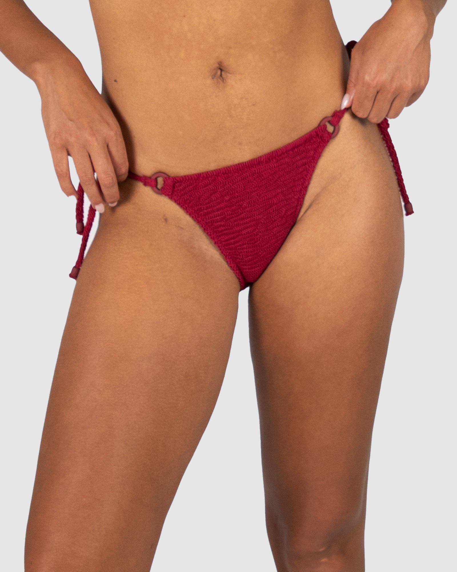 Ibiza Rio Tie Side Bikini Bottom in scarlet crinkle fabric with adjustable hip ties and cheeky rio-style back coverage from Australian swimwear brand Baku.