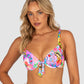 Woman wearing a colorful floral bikini top against a plain background
