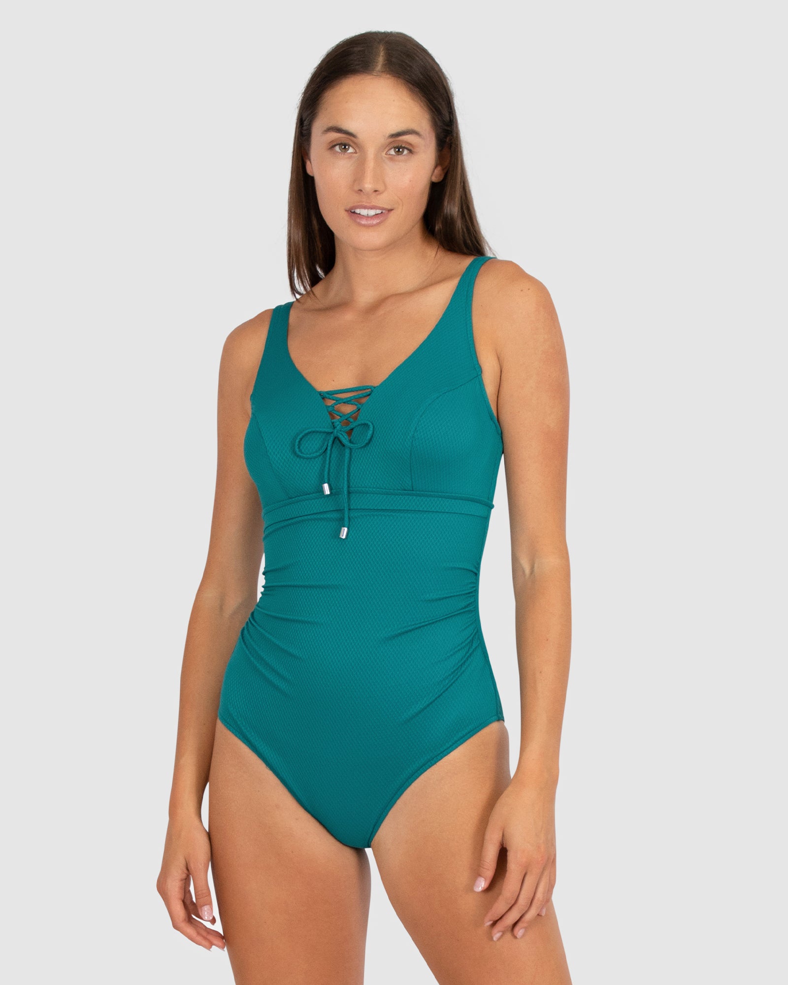 aku is a premium Australian swimwear brand. The Rococco E-F-G One Piece Swimsuit in Jungle, a bold and deep green inspired by tropical foliage, is designed to support and shape. Made from Spanish-developed textural fabric, it includes a lace-up neckline, hidden underwire, power mesh stability, boning, Lycra cup support, tummy control, and a clip back, all finished with convertible adjustable straps for flexibility.