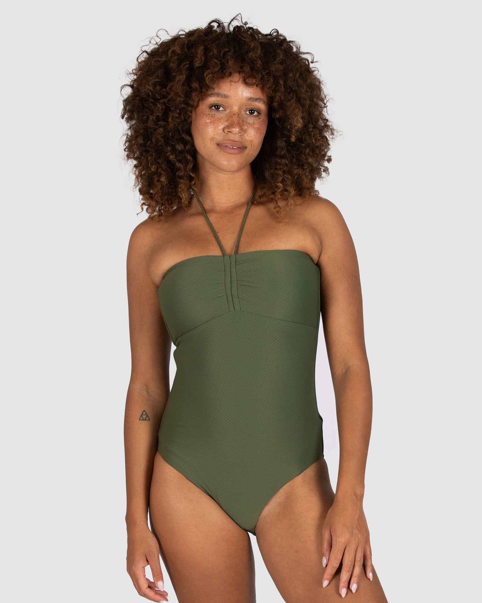 Baku is a premium Australian swimwear brand. The Rococco Multi Fit Bandeau One Piece in Amazon, a deep olive green inspired by nature, provides a secure and flattering strapless silhouette. With soft removable cups, boning support, gripper tape, and an optional neck tie, this piece is made from luxurious Spanish fabrication for multi-cup fit and elegant support.