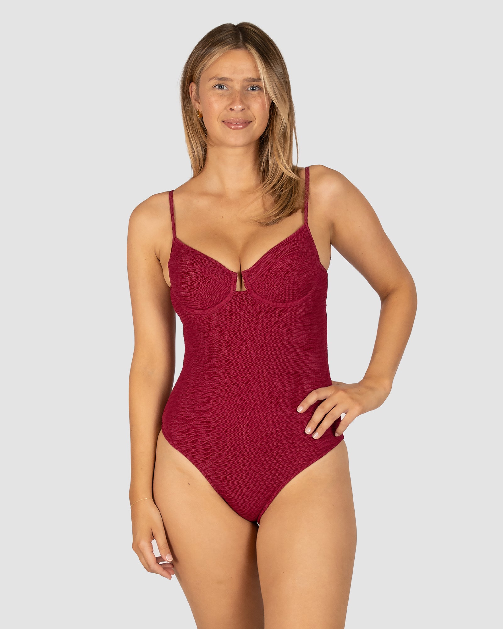 Ibiza D–DD Cup Underwire Bandeau One Piece in scarlet crinkle fabric with supportive hidden underwire, boning structure, removable cups, U-trim detail, and detachable straps from Australian swimwear brand Baku.