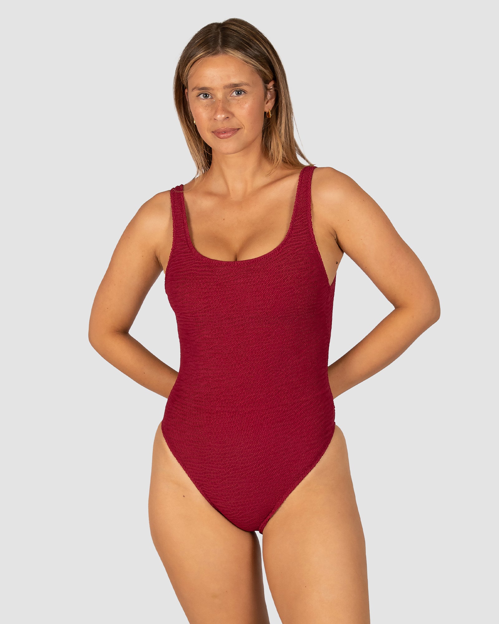 Ibiza Low Back One Piece in scarlet crinkle fabric with elongated legline, low back, rio bottom coverage, removable cups, and shelf support from Australian swimwear brand Baku.