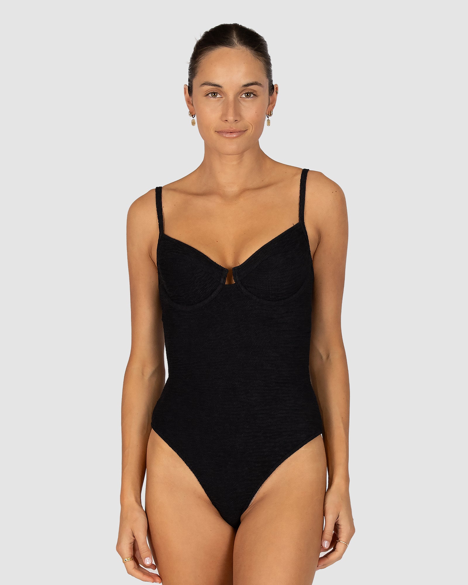 Ibiza D–DD Cup Underwire Bandeau One Piece in black crinkle fabric designed with hidden underwire and boning, U-trim accent, removable soft cups, clip-on straps, and gripper elastic for secure wear by Australian swimwear brand Baku.