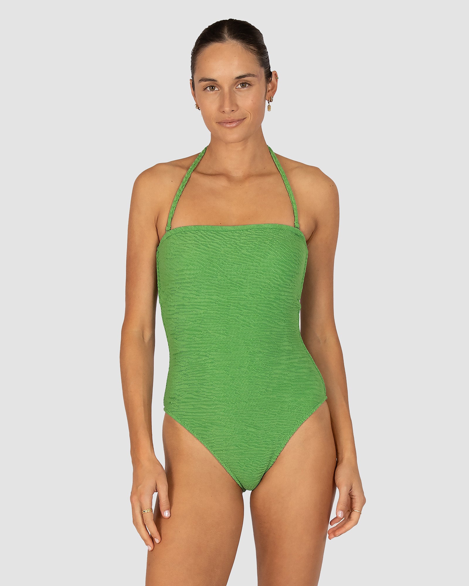 Ibiza Bandeau One Piece in moss crinkle fabric offering removable cups, shelf support, gripper elastic, and modern streamlined silhouette with high leg cut from Australian swimwear brand Baku.