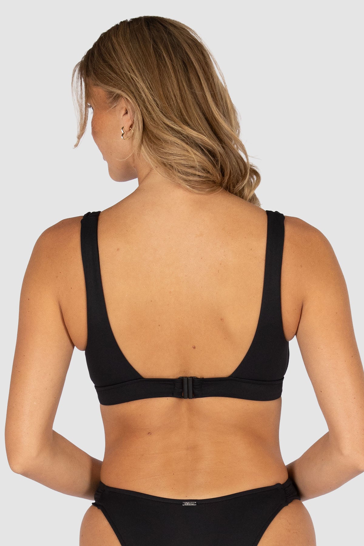 Baku is an Australian swimwear brand. Core Longline Bikini Bra Top back view with clip back closure, longline band and supportive bikini top design.