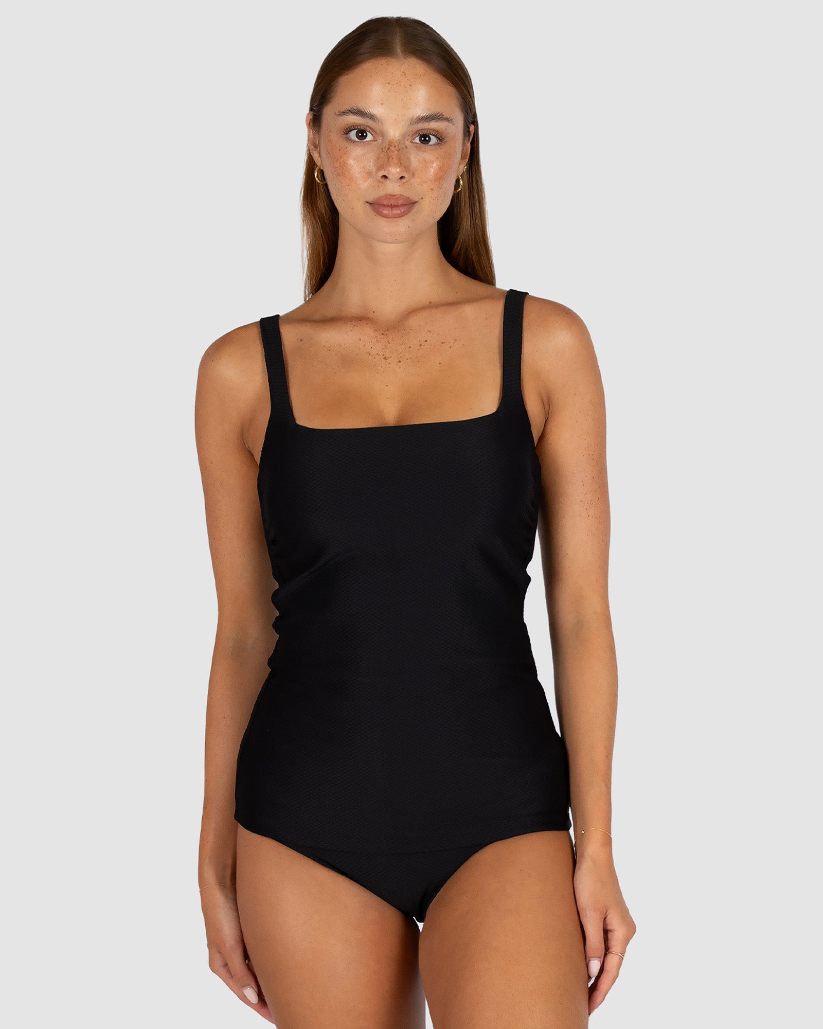 Baku is a premium Australian swimwear brand. The Rococco Multi Fit Singlet Top in Nero, a timeless classic black, combines elegant minimalism with sculpting function. Crafted from soft Spanish textured fabric, it includes removable cups, boning support, and versatile adjustable straps, offering a flattering and supportive fit for A to DD cups.